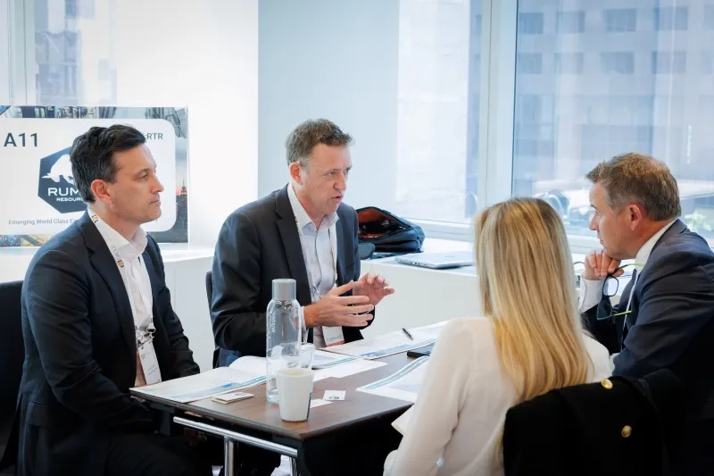 Mining company representatives discussing opportunities with investors at 121 Dallas